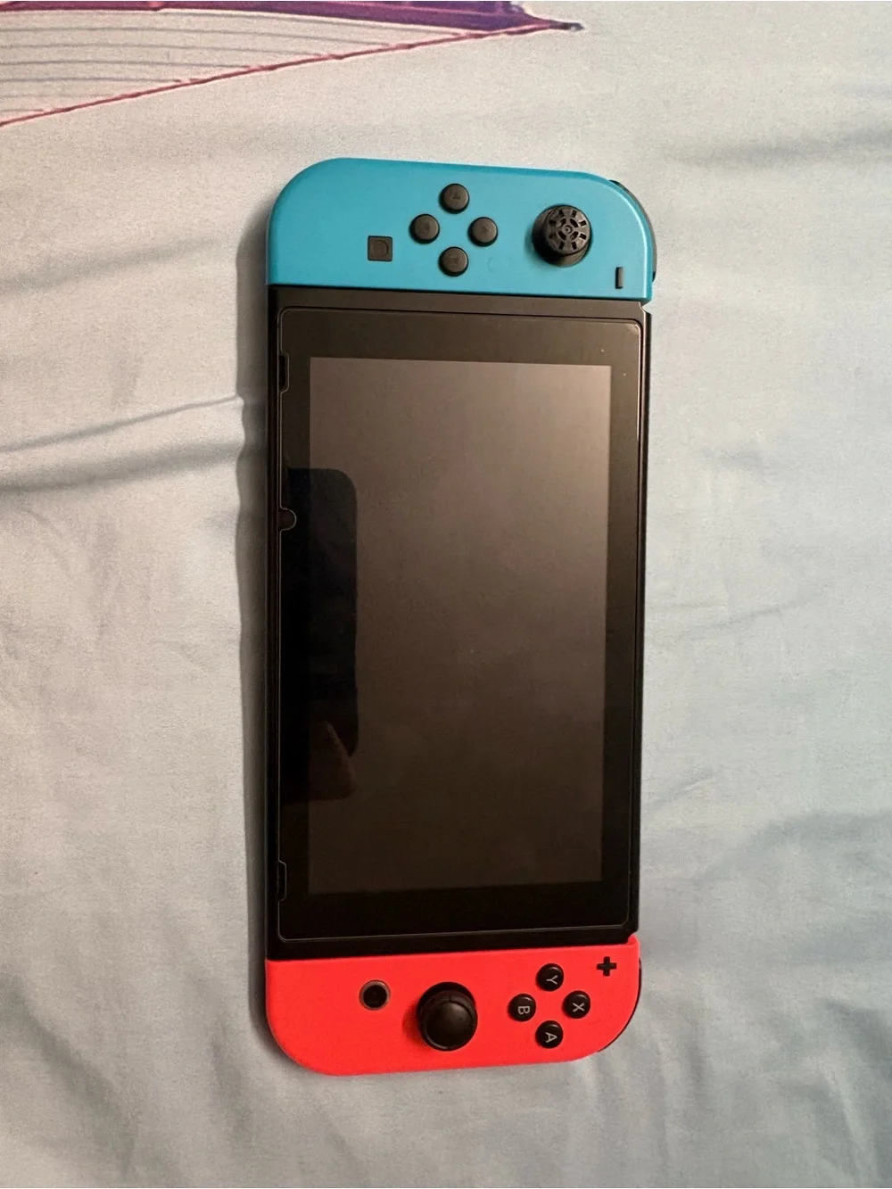 Nintendo Switch with Neon Red Right Joy‑Con and Neon Blue Left Joy‑Con